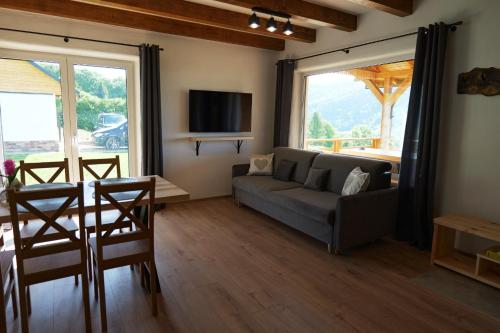 a living room with a couch and a table at Słońce i cień in Baligród