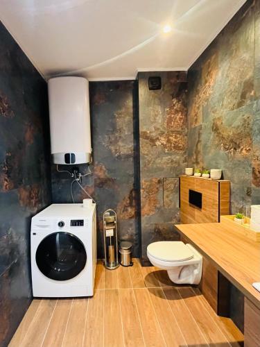 a bathroom with a toilet and a sink at SEAVIEW BG Beach Front Suites in Golden Sands