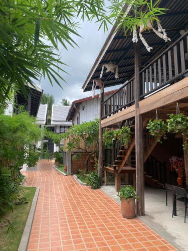a brick walkway in front of a building at Luang Prabang Vang Luang Hotel in Luang Prabang