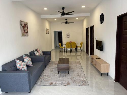 a living room with a couch and a table at D' Ehsan Homestay & Chalet in Kuala Terengganu