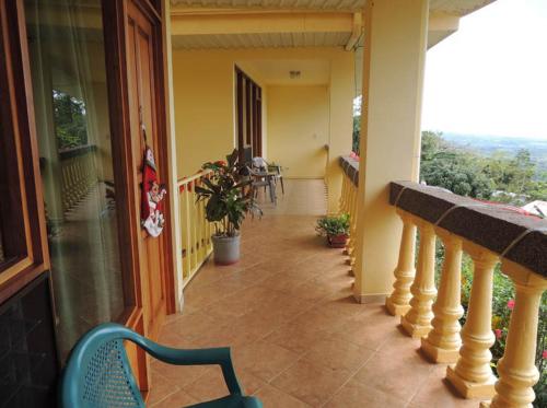 a balcony of a house with a table and chairs at La Princesa Hotel in San Isidro