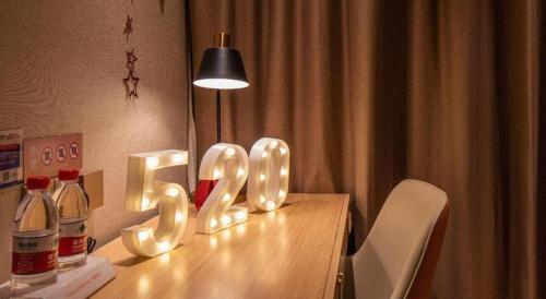 a wooden table with a sign that says love at Vienna Hotel Hangzhou East Railway Station West Square in Hangzhou