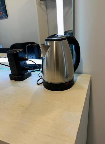 a tea kettle sitting on top of a desk at Pequeña París Coyoacán, Habitación Privada WiFi in Mexico City