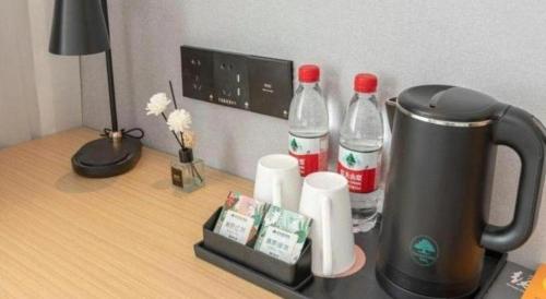 a counter with two bottles of cocacola on a desk at GreenTree Inn Express Qingdao Jiaodong International Airport in Qingdao