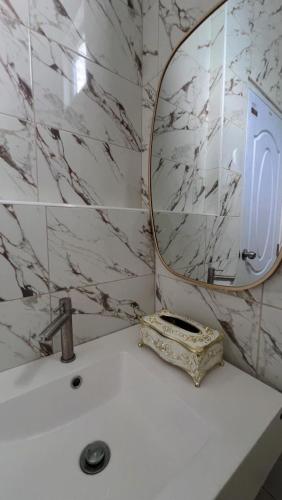 a bathroom with a mirror and a white sink at Hadkaew Thepha Pool Villa by Jehsana in Ban Krong I Tam