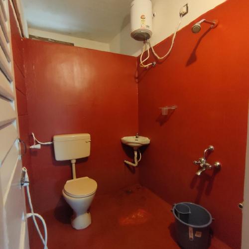 a bathroom with a toilet and a sink at Vanam Soulful Stays in Puducherry