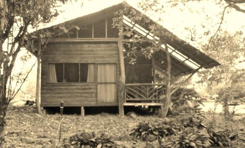 a small wooden house with a large window at Vocaré Finca Agroecológica in Upala