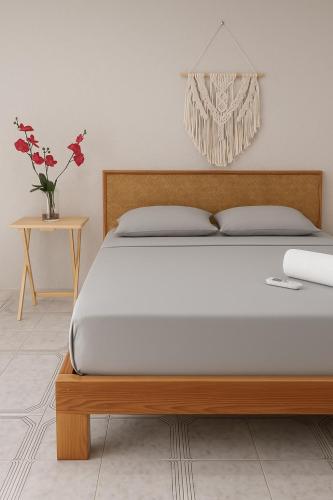 a bedroom with a bed and a vase with flowers at Burgos Studio in Cancún