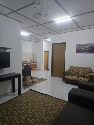 a living room with a couch and a table at D Tasek Homestay Lenggong 