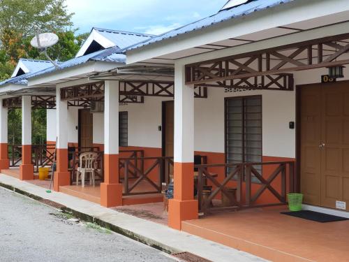a small house with orange and white at D Tasek Homestay Lenggong 