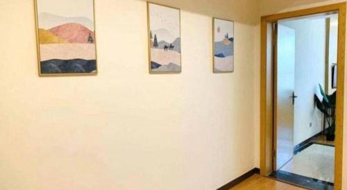 a room with four pictures on a wall at GreenTree Inn Nantong University Industrial Expo City Express Hotel in Nantong