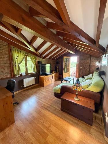 a large room with two beds and a tv at Chalet con zona de asador en Quijas in Valles