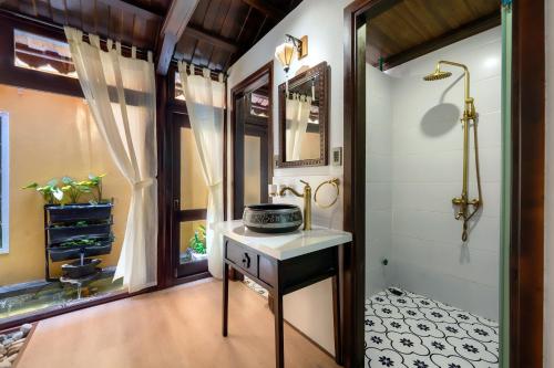a bathroom with a sink and a shower at Hội An Wooden Retreat In Town in Hoi An