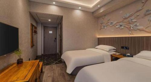 Un ou plusieurs lits dans un hébergement de l'établissement Xi'an Huiya Tianmu Hotel