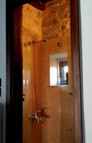 a shower stall with a mirror in a bathroom at Mani Fort Charabos in Ayía Kiriakí