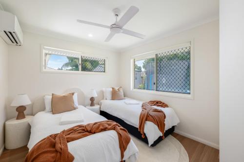 Ένα ή περισσότερα κρεβάτια σε δωμάτιο στο Urban Getaway Bargara Central