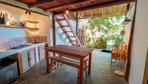 a kitchen with a wooden table and a ladder at Zen Treehouse in General Luna