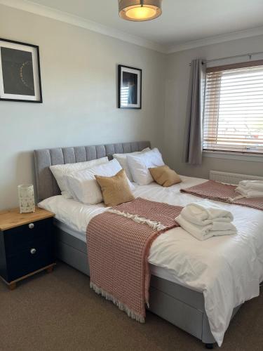 two beds sitting next to each other in a bedroom at Covesea Horizon in Elgin