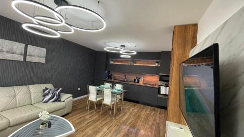 a living room with a couch and a table at Тони апартмент in Burgas City