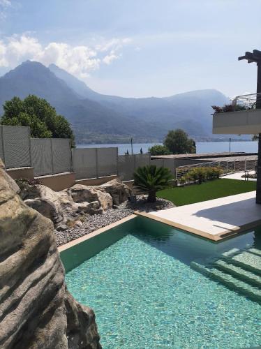 a swimming pool in a yard with a rock wall at Villa Orchidea in Onno