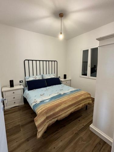 a bedroom with a bed and two night stands at Casa Tonzi in Orosei