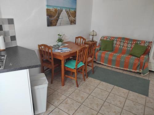 una cucina con tavolo, sedie e un divano di Verde casa eden a Tías