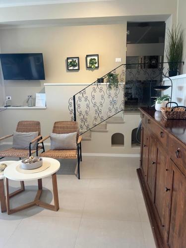 a living room with a staircase and a table at IL MARE BLU in Lerici