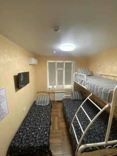 una habitación con dos literas y una ventana en Hostel 5 Capsule Rooms & Comfort Rooms, en Öskemen