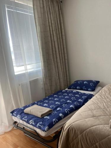 a bed sitting in a room next to a window at KEY Accommodation Brno in Brno