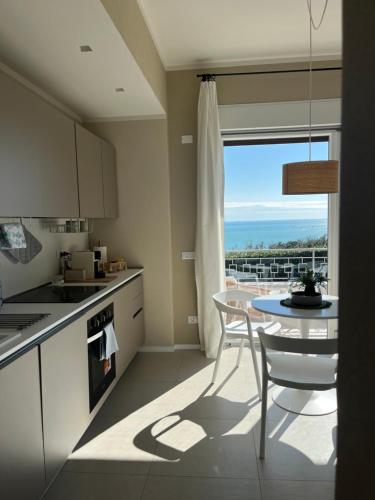 a kitchen and dining room with a table and a window at IL MARE BLU in Lerici