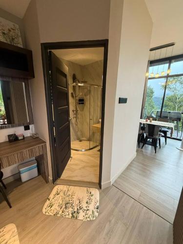a room with a glass door leading to a bathroom at Green Therapy Cottage in Ranau