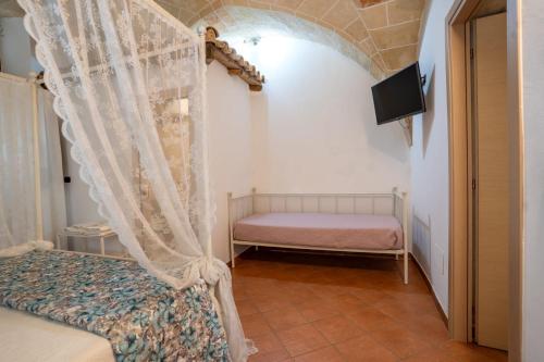 a bedroom with a bed and a window with a curtain at LA ULIA by SALENTO OASIS in Copertino