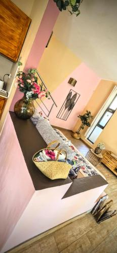 a living room with a table and a vase with flowers at Villa centre Grand Baie in Grand Baie