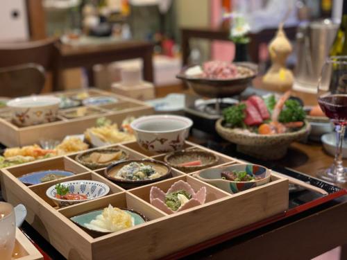 a table filled with dishes of food on a table at Hot Spring Inn Hyoutan in Kusatsu