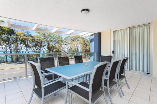 a dining room with a blue table and chairs at Beach House on Suttons in Redcliffe