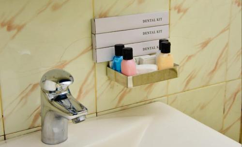 a bathroom sink with a faucet next to a sink at Forest Edge Holiday Inn in Nuwara Eliya