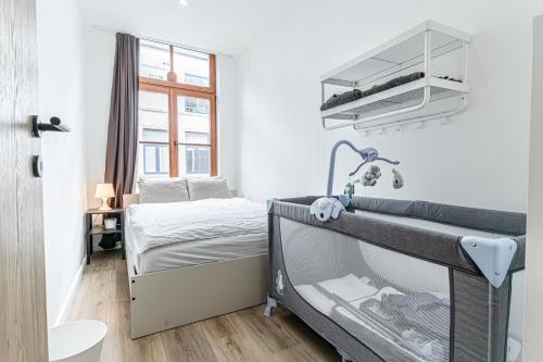 a small white bedroom with a bed and a window at Elegant 3BR & 1LR Waterfront Retreat in Ghent in Ghent