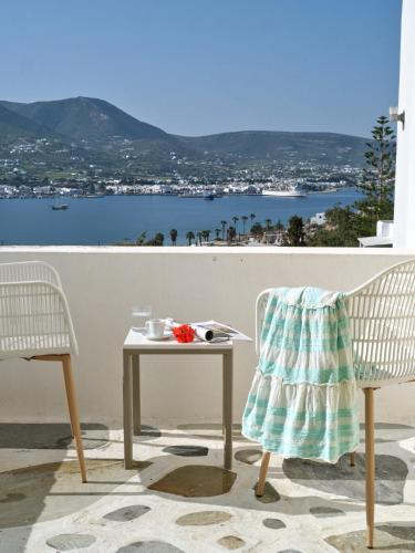 a table and two chairs sitting on a balcony with a view at Akrotiri Hotel in Parikia