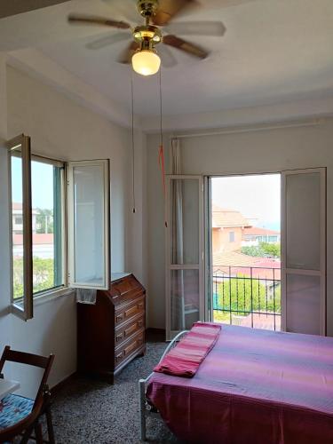 a bedroom with a bed and a ceiling fan at Villa Mirabelli in Tropea