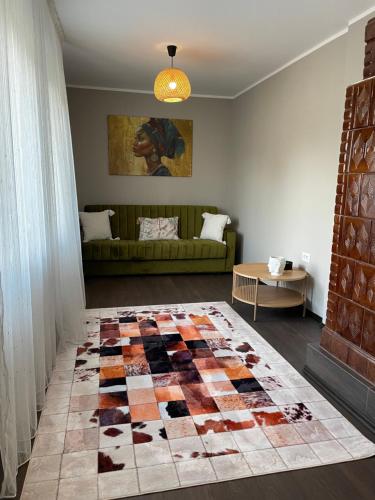 a living room with a couch and a rug at Casa Din Deal in Huşi