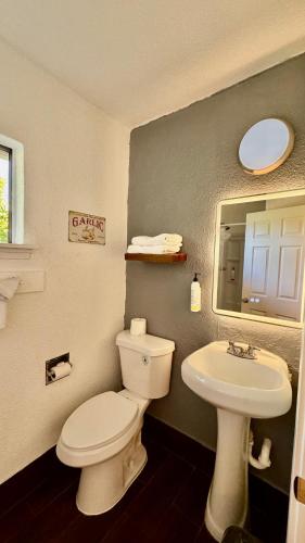 a bathroom with a white toilet and a sink at Budget Motel in Gilroy