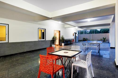 a dining room with chairs and a table and a table and chairsktop at Palette 4 Colors in Lingampalli