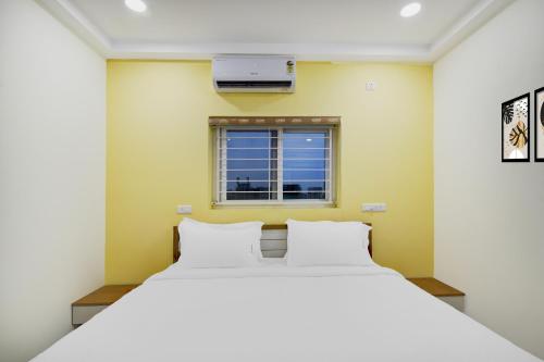 a bedroom with a white bed and a window at Palette 4 Colors in Lingampalli