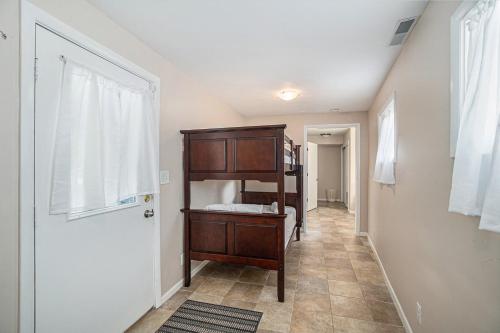 a room with a book shelf and a door at Spacious 4BDR Blue Haven Cottage in Grand Haven 150 in Grand Haven