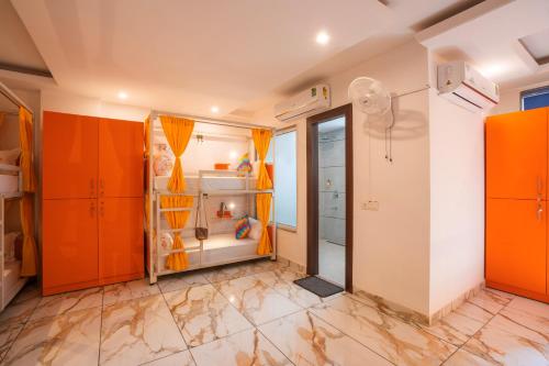 a room with orange cabinets and a shower in it at goSTOPS PLUS Gurugram, Baani Square in Gurgaon