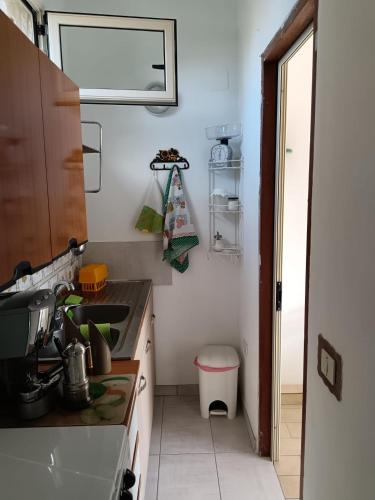 a small kitchen with a sink and a stove at Villa Mirabelli in Tropea