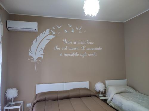 a bedroom with a bed with a quote on the wall at Bed and Breakfast Oasi in Reggio Calabria