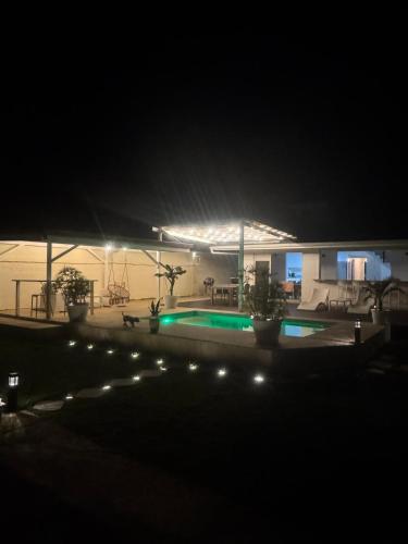a swimming pool at night with lights at Villa Hana'iki in Paui