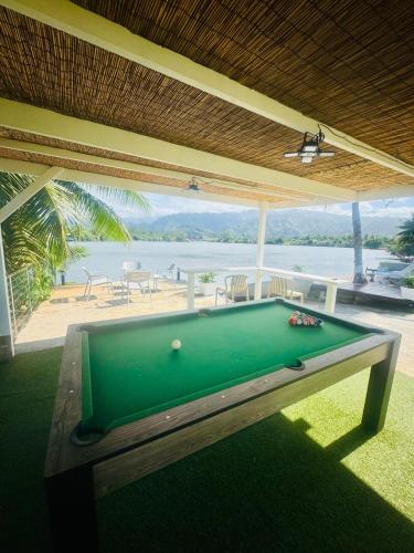 a pool table in a room with a view of the ocean at Villa Hana'iki in Paui