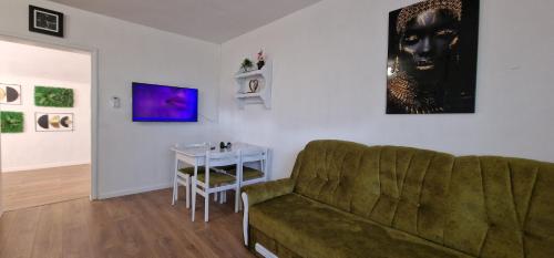 a living room with a couch and a table at Vikendica Iris in Laktaši